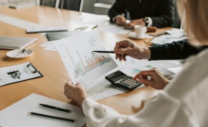 Professionals reviewing financial graphs and charts during a meeting.