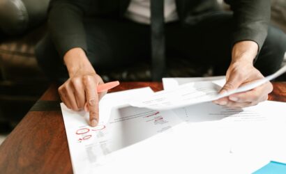 A businessman analyzing financial documents with important data and figures on a desk, ideal for business analytics and accounting themes.